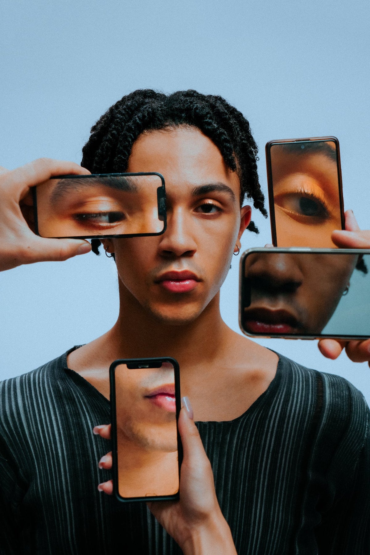 Portrait framed by phone screens
