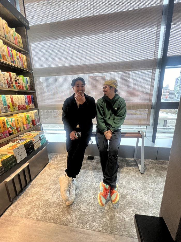 Aaron and a teammate by a bookstore window